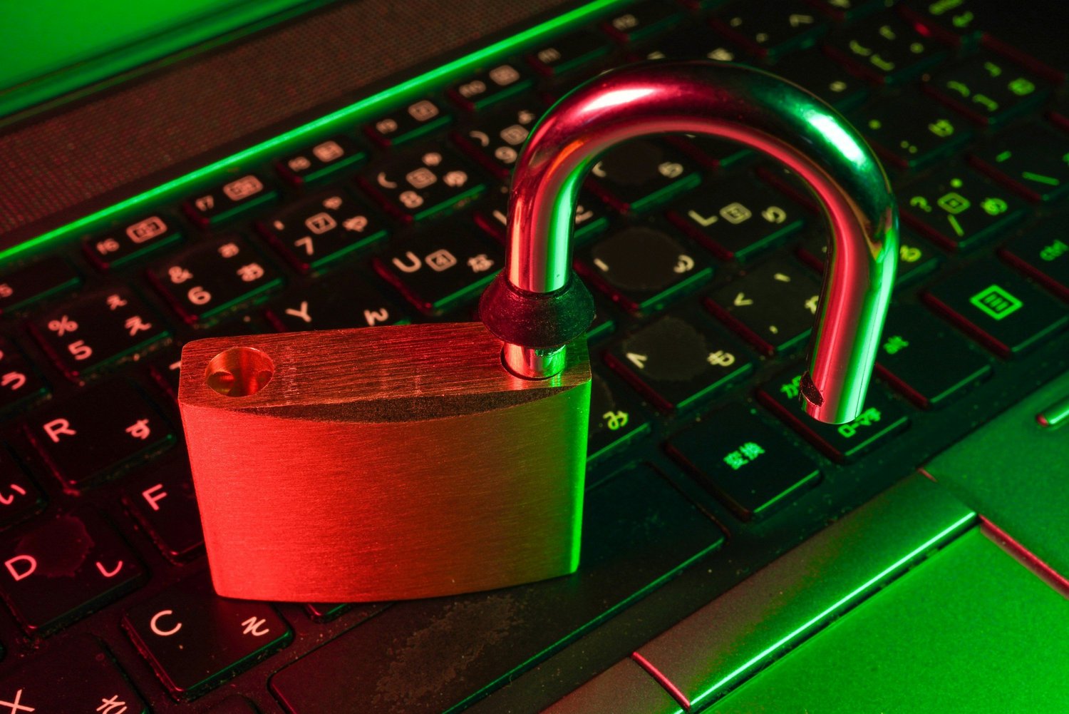 A keyboard with an unlocked padlock on it.